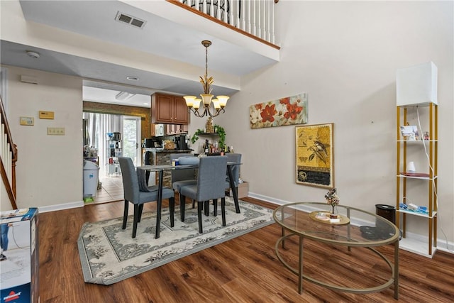 302 Malcolm Ct, Monroeville, PA 15146 - dining area with stairs, wood finished floors, and a chandelier