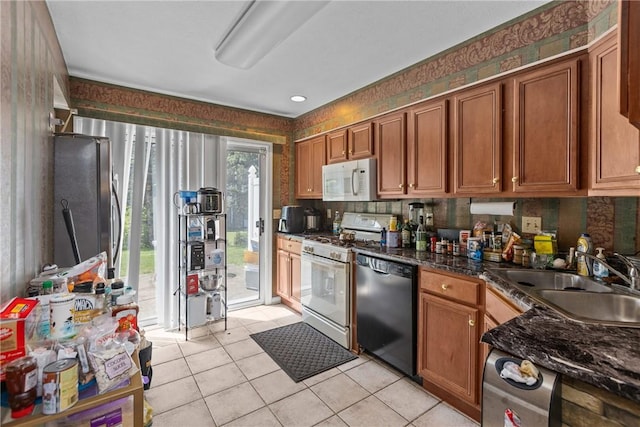 302 Malcolm Ct, Monroeville, PA 15146 - kitchen featuring white appliances, light tile patterned floors, brown cabinetry, and wallpapered walls