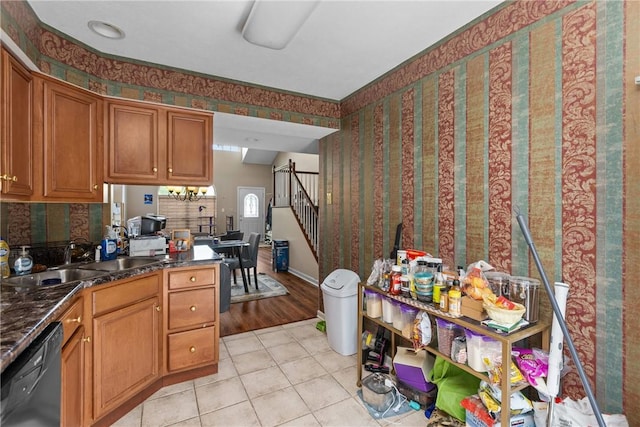 302 Malcolm Ct, Monroeville, PA 15146 - kitchen featuring dishwashing machine, brown cabinetry, light tile patterned floors, and dark countertops