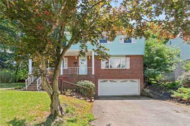 718 Twin Oak Dr, Penn Hills, PA 15235 - view of front of house featuring a garage, asphalt driveway, brick siding, and a front lawn