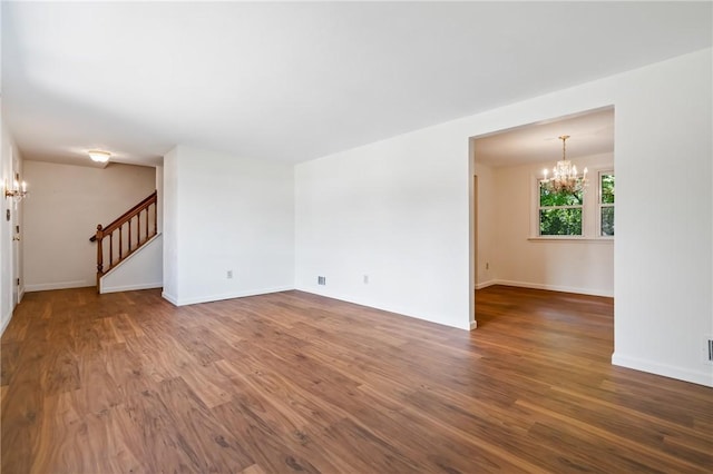 718 Twin Oak Dr, Penn Hills, PA 15235 - unfurnished room featuring a chandelier, stairs, and wood finished floors