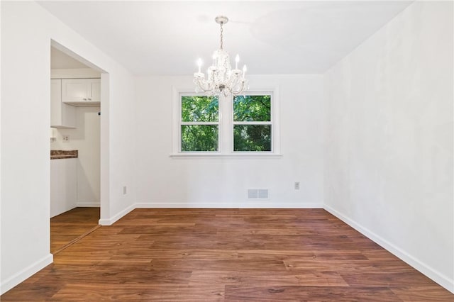 718 Twin Oak Dr, Penn Hills, PA 15235 - unfurnished dining area featuring a chandelier and wood finished floors