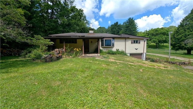 89 Rankin Rd, Wharton Twp, PA 15437 - view of front of house featuring a garage, a front lawn, a chimney, and view of scattered trees