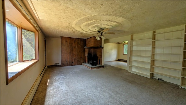 89 Rankin Rd, Wharton Twp, PA 15437 - unfurnished living room featuring a baseboard radiator, ceiling fan, carpet floors, healthy amount of natural light, and a textured ceiling