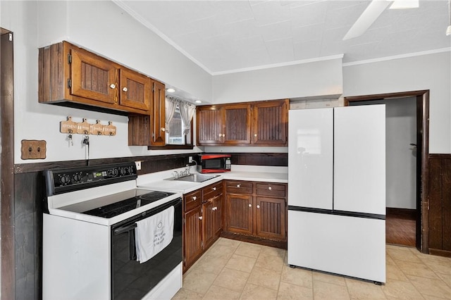 2509 Thomas St, Hempfield Twp, PA 15634 - kitchen with freestanding refrigerator, electric stove, crown molding, light countertops, and light tile patterned flooring