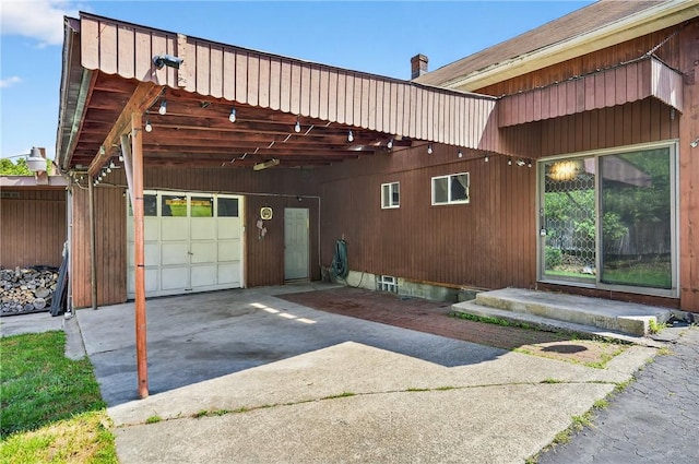 2509 Thomas St, Hempfield Twp, PA 15634 - view of side of home featuring driveway, an attached garage, and a carport