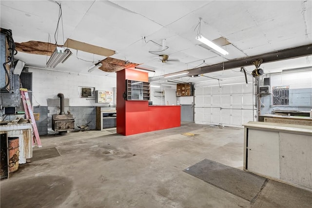 2509 Thomas St, Hempfield Twp, PA 15634 - garage featuring a wood stove and a ceiling fan