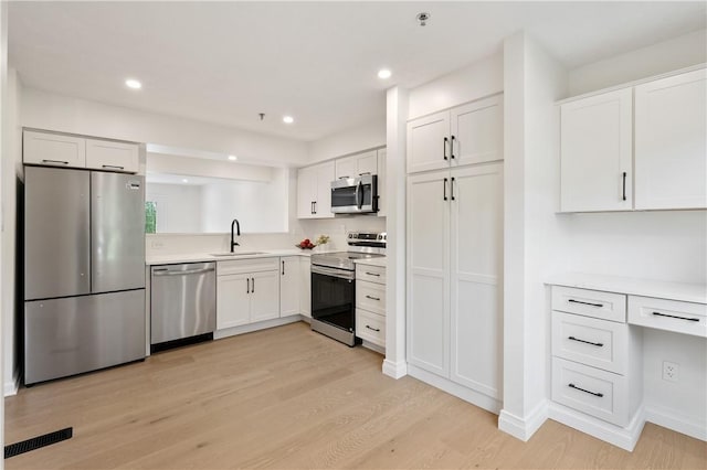 1278 Meadowbrook Dr, North Strabane, PA 15317 - kitchen with stainless steel appliances, light wood finished floors, white cabinetry, light countertops, and recessed lighting