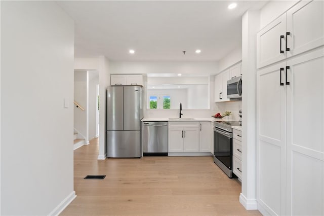 1278 Meadowbrook Dr, North Strabane, PA 15317 - kitchen featuring stainless steel appliances, white cabinets, light countertops, light wood-style floors, and recessed lighting