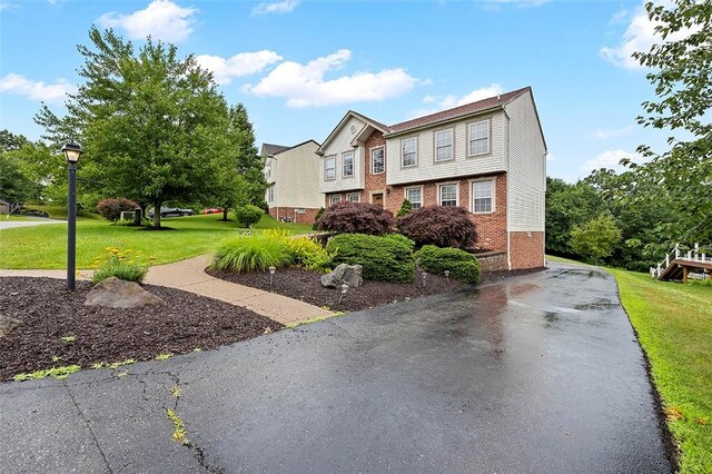 1071 Shawnee Ridge Dr, Cheswick, PA 15024 - view of front of home featuring brick siding, a front lawn, asphalt driveway, and a residential view