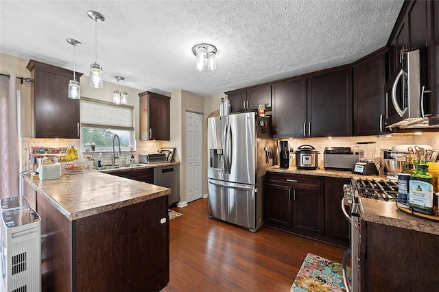 1071 Shawnee Ridge Dr, Cheswick, PA 15024 - kitchen featuring stainless steel appliances, dark brown cabinets, dark wood-style floors, tasteful backsplash, and a textured ceiling