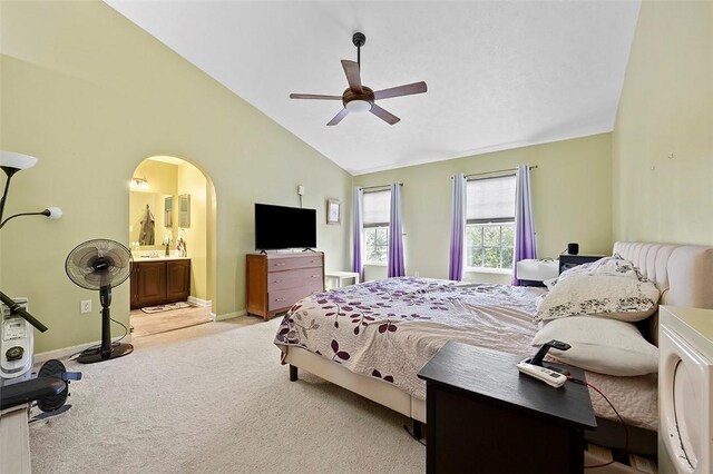 1071 Shawnee Ridge Dr, Cheswick, PA 15024 - carpeted bedroom featuring vaulted ceiling, arched walkways, ensuite bathroom, and a ceiling fan