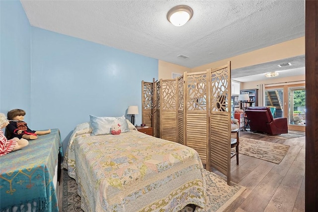 1071 Shawnee Ridge Dr, Cheswick, PA 15024 - bedroom with a textured ceiling and hardwood / wood-style floors