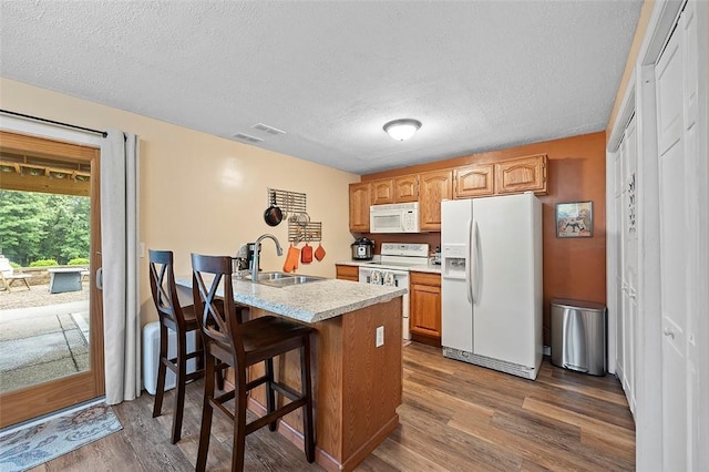 1071 Shawnee Ridge Dr, Cheswick, PA 15024 - kitchen with white appliances, dark wood-style floors, light countertops, a textured ceiling, and a breakfast bar