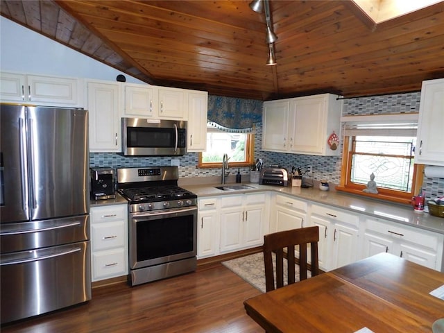 118 Harrison St, Elizabeth Twp/Boro, PA 15037 - kitchen with stainless steel appliances, lofted ceiling, tasteful backsplash, white cabinetry, and wooden ceiling