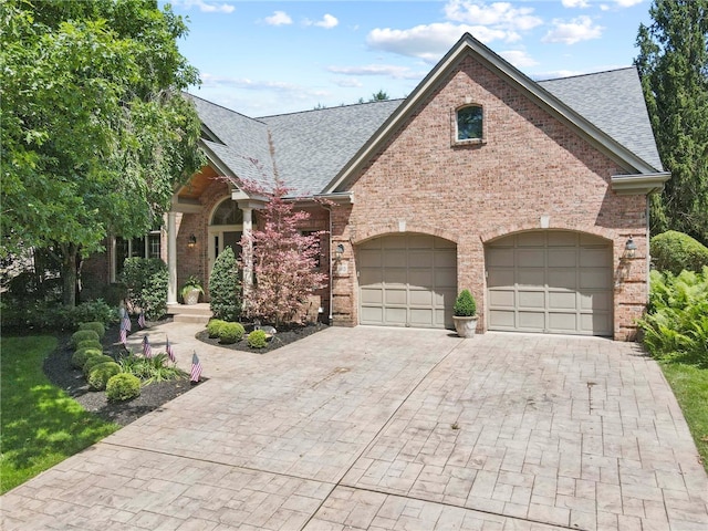 1413 Oak St, Oakmont, PA 15139 - view of front of house featuring a shingled roof, brick siding, decorative driveway, and an attached garage