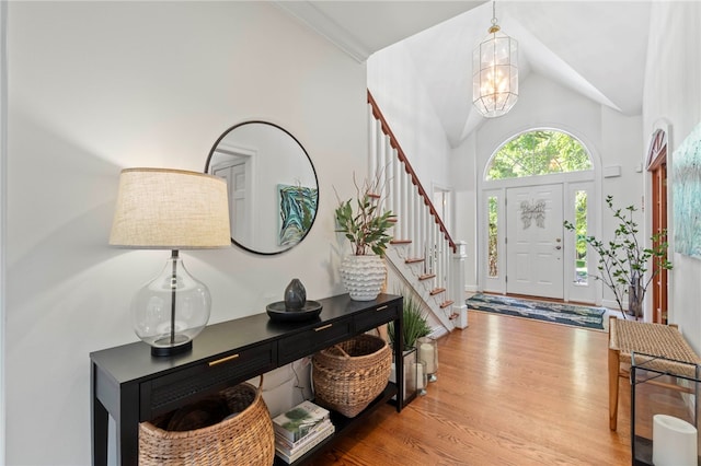 1413 Oak St, Oakmont, PA 15139 - foyer entrance featuring wood finished floors, a chandelier, stairs, and high vaulted ceiling