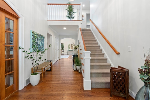 1413 Oak St, Oakmont, PA 15139 - foyer entrance with arched walkways, wood finished floors, stairs, and recessed lighting