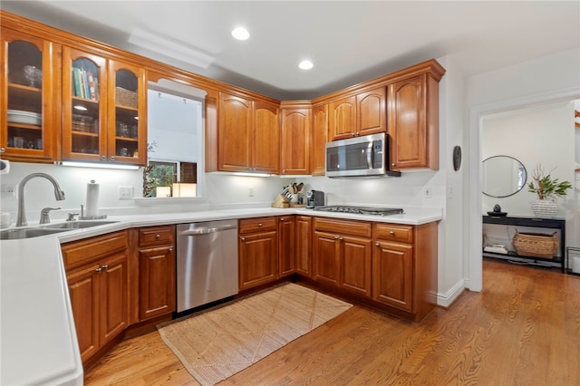 1413 Oak St, Oakmont, PA 15139 - kitchen with appliances with stainless steel finishes, light wood-type flooring, glass insert cabinets, light countertops, and recessed lighting