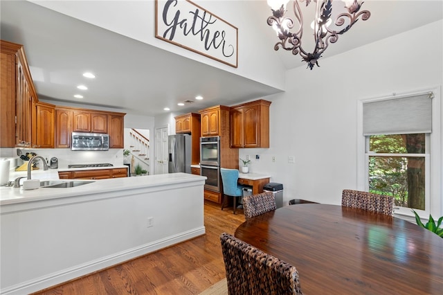 1413 Oak St, Oakmont, PA 15139 - kitchen featuring stainless steel appliances, a chandelier, wood finished floors, recessed lighting, and a peninsula