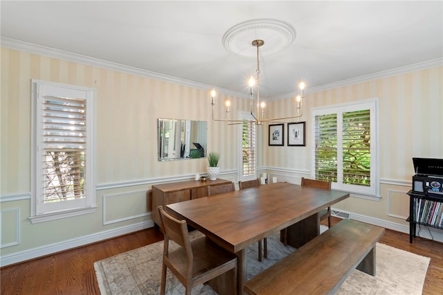 1413 Oak St, Oakmont, PA 15139 - dining room featuring wood finished floors, crown molding, a wainscoted wall, a chandelier, and a decorative wall