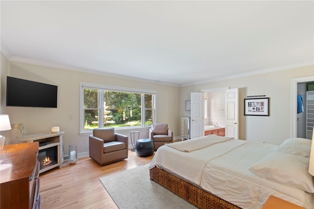 1413 Oak St, Oakmont, PA 15139 - bedroom with crown molding, light wood finished floors, a glass covered fireplace, and ensuite bath