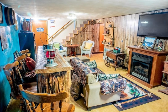 3015 Graham Ave, Windber, PA 15963 - living area with stairs, wood walls, a fireplace, and carpet