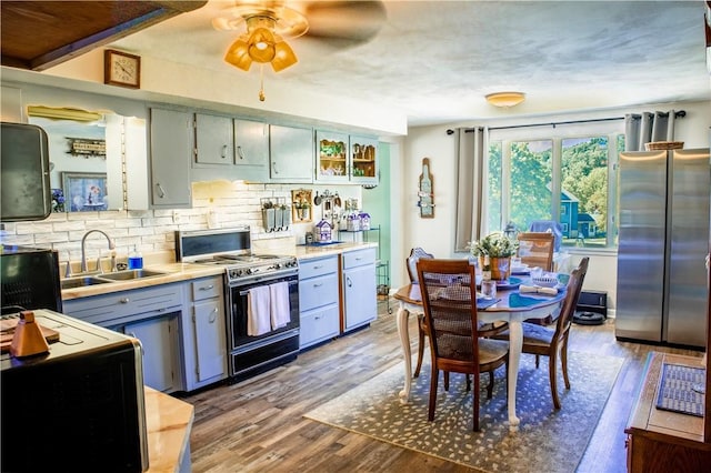 3015 Graham Ave, Windber, PA 15963 - kitchen with black / electric stove, freestanding refrigerator, wood finished floors, tasteful backsplash, and ceiling fan