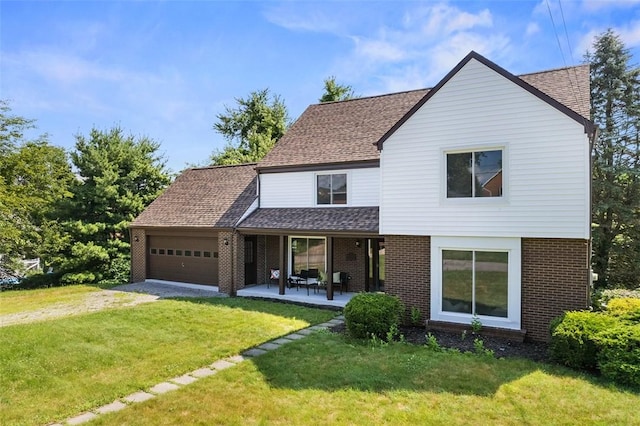 1014 Olga St, Ambridge, PA 15003 - view of front of property with driveway, brick siding, an attached garage, a front lawn, and roof with shingles