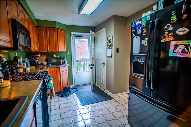 622 National Dr, Penn Hills, PA 15235 - kitchen with black appliances, light floors, and brown cabinetry