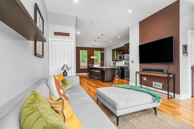 611 Suismon St, East Allegheny, PA 15212 - living area with light wood finished floors and recessed lighting