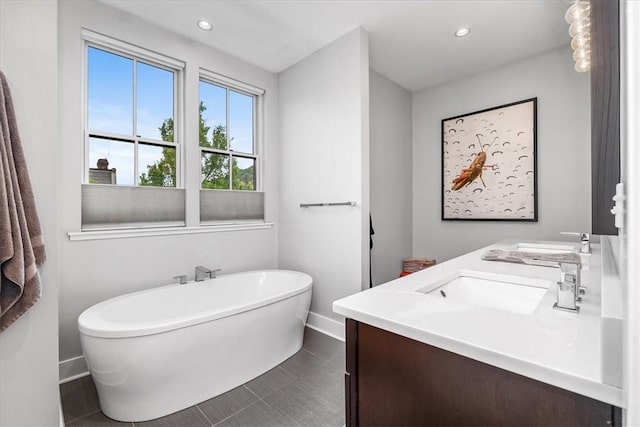 611 Suismon St, East Allegheny, PA 15212 - bathroom featuring a freestanding bath, double vanity, and recessed lighting