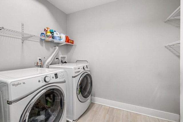 611 Suismon St, East Allegheny, PA 15212 - laundry room featuring washer and dryer and light wood-style floors