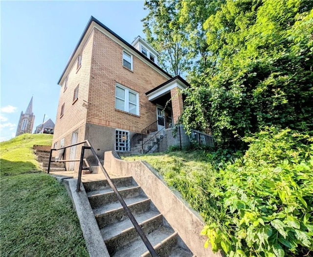 213 N 5th St, Jeannette, PA 15644 - rear view of property with stairway and brick siding