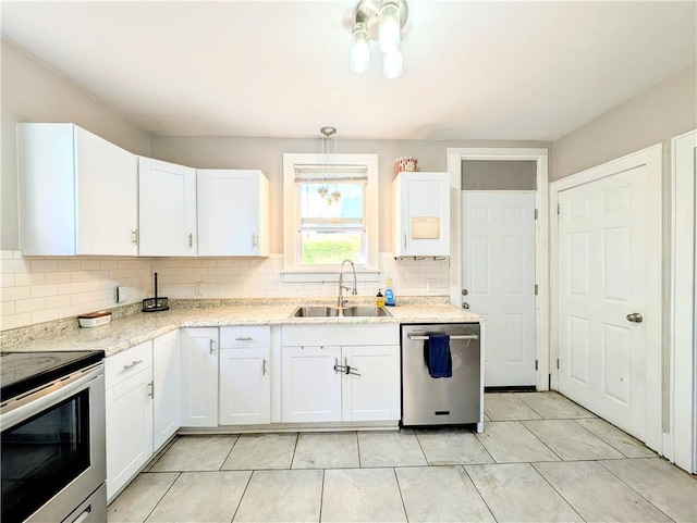 213 N 5th St, Jeannette, PA 15644 - kitchen with stainless steel appliances, tasteful backsplash, white cabinets, light tile patterned floors, and light stone counters