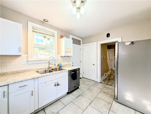 213 N 5th St, Jeannette, PA 15644 - kitchen featuring appliances with stainless steel finishes, decorative backsplash, white cabinets, and light tile patterned floors