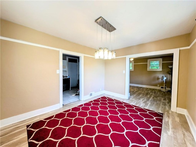 213 N 5th St, Jeannette, PA 15644 - unfurnished dining area with wood finished floors and baseboards