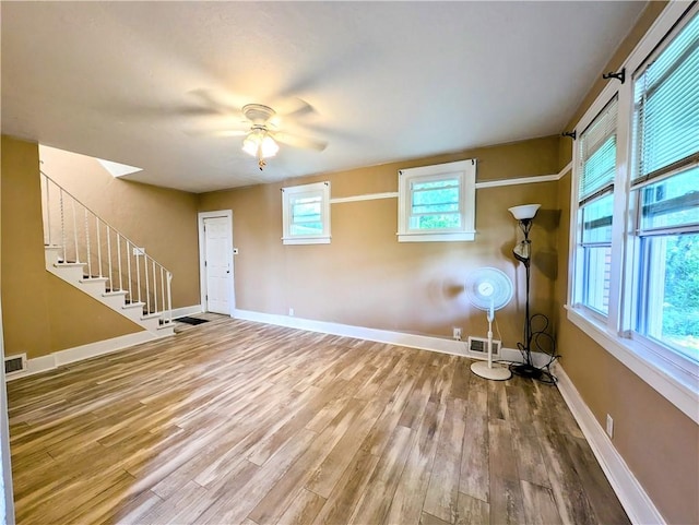 213 N 5th St, Jeannette, PA 15644 - unfurnished living room with ceiling fan, wood finished floors, and stairs