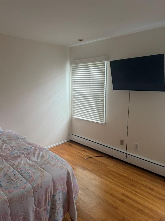 105 White Oak Dr, Twp Of But Se, PA 16001 - bedroom featuring a baseboard radiator and light wood-style floors