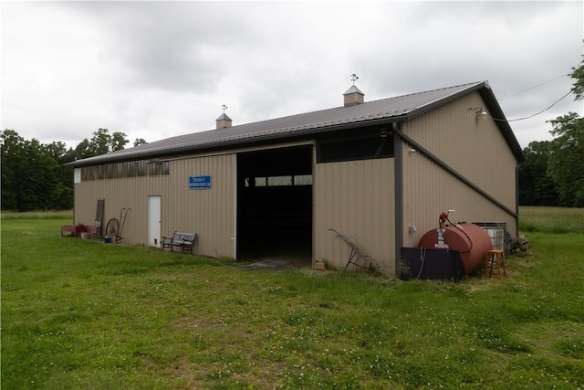 2681 Mallory Rd, Pa, PA 16314 - view of property exterior with a detached garage, an outbuilding, a yard, and a metal roof