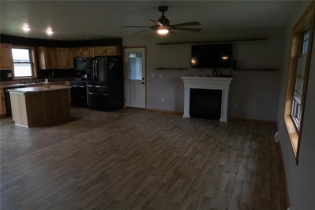 2681 Mallory Rd, Pa, PA 16314 - kitchen with black appliances, open floor plan, wood finished floors, and a kitchen island