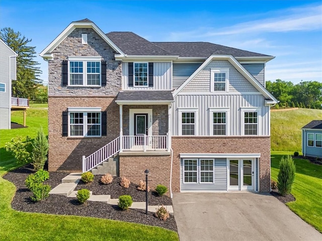 1103 Deerfield Dr, Franklin Park, PA 15143 - view of front of property featuring board and batten siding, brick siding, a front lawn, and asphalt driveway