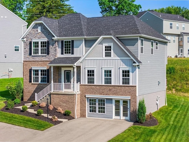 1103 Deerfield Dr, Franklin Park, PA 15143 - view of front facade with board and batten siding, brick siding, a front lawn, and a shingled roof