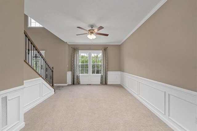 1103 Deerfield Dr, Franklin Park, PA 15143 - empty room with ceiling fan, light carpet, a decorative wall, a wainscoted wall, and stairway