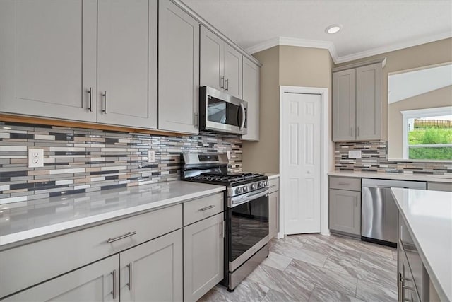1103 Deerfield Dr, Franklin Park, PA 15143 - kitchen featuring appliances with stainless steel finishes, gray cabinetry, backsplash, light countertops, and ornamental molding