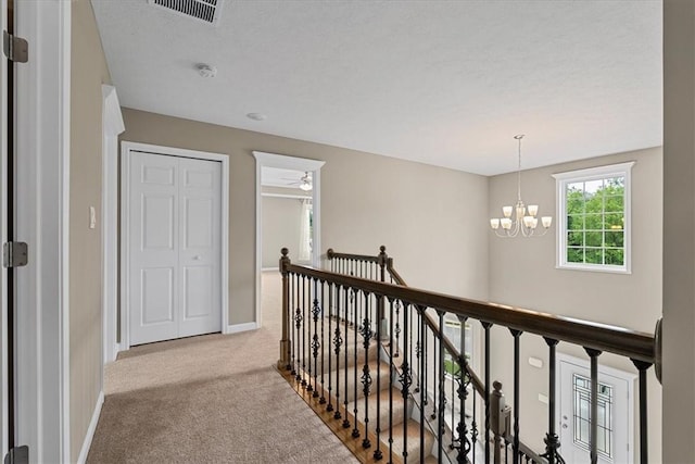 1103 Deerfield Dr, Franklin Park, PA 15143 - corridor featuring an upstairs landing, carpet, and a chandelier