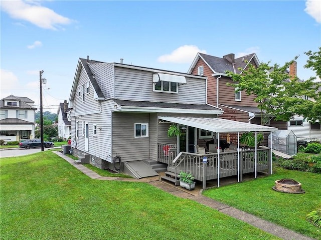 915 Summit St, Mckeesport, PA 15132 - view of front facade featuring a fire pit, a wooden deck, an exterior structure, and a front lawn