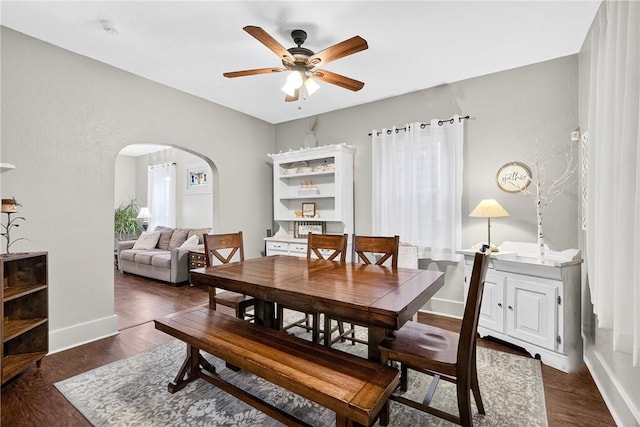 915 Summit St, Mckeesport, PA 15132 - dining area featuring arched walkways, ceiling fan, and wood finished floors
