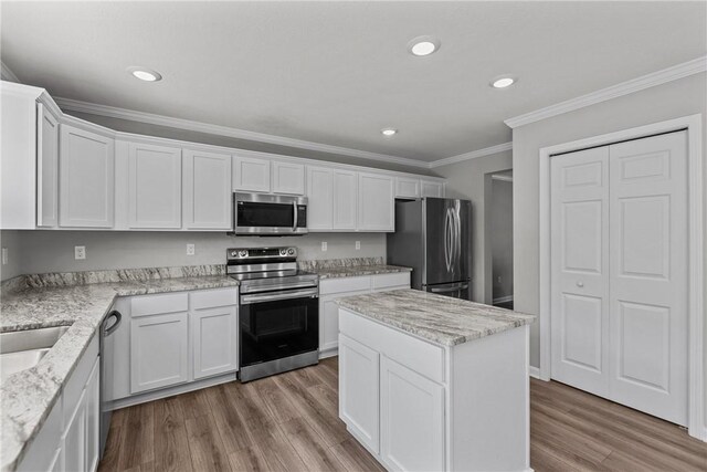 260 Lily Ridge Dr, North Strabane, PA 15317 - kitchen with stainless steel appliances, white cabinetry, crown molding, light wood-style floors, and a kitchen island