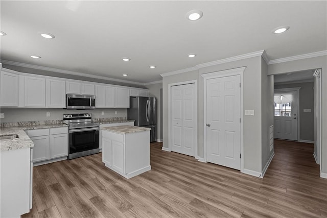 260 Lily Ridge Dr, North Strabane, PA 15317 - kitchen featuring stainless steel appliances, ornamental molding, a kitchen island, recessed lighting, and white cabinets